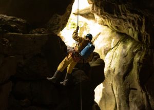 Persona realizando espeleología, una actividad de turismo activo